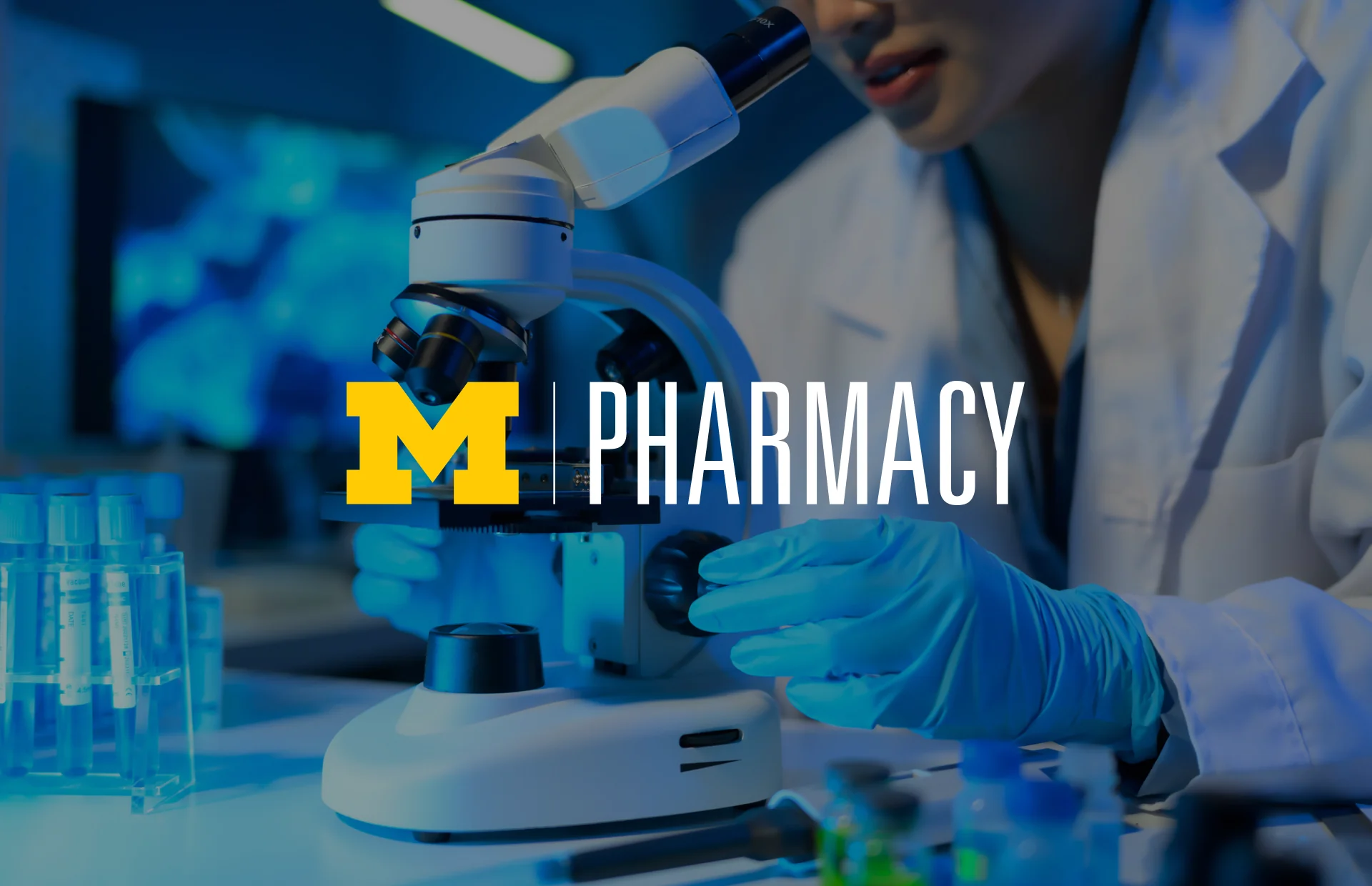 U-M College of Pharmacy cover — a researcher at a microscope in blue light, with the Michigan Pharmacy logo.
